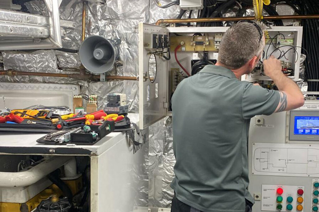 Smart Yachts electrician specialising in marine technology in a yacht engine room